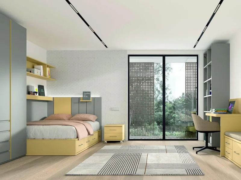 Habitación juvenil en amarillo y gris, con cama de cajones, escritorio corrido y estantería.